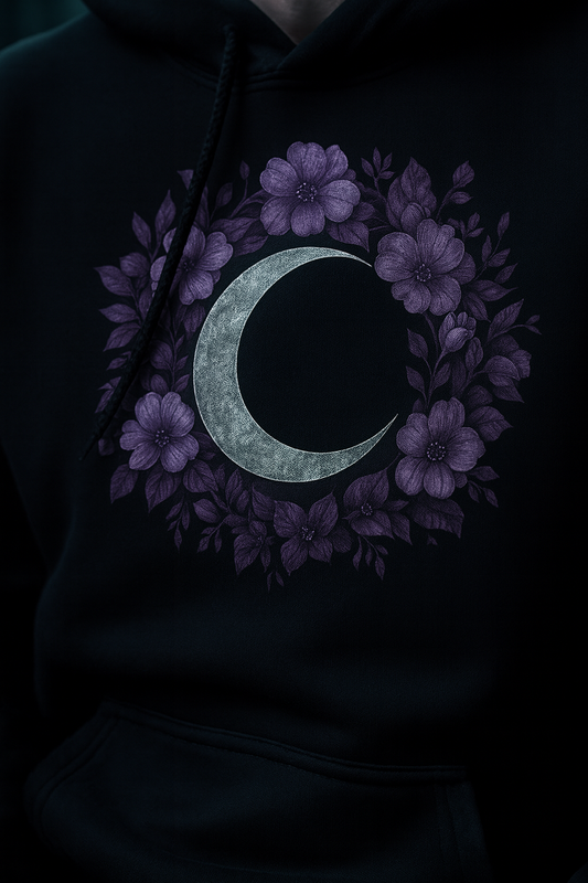 Black hoodie with a crescent moon and floral design on a dark background